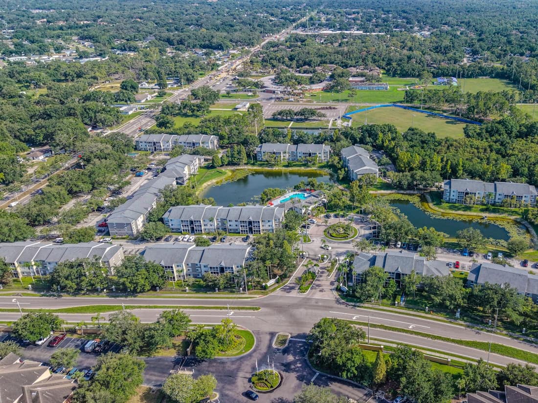 Aerial view of a multifamily community set around ponds and open space