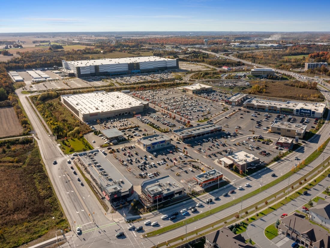 Aerial view of a retail center with an anchor store, pad sites, and parking